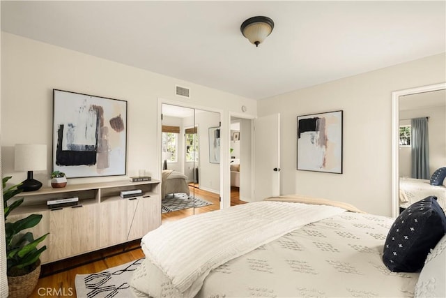 bedroom featuring visible vents and dark wood-type flooring