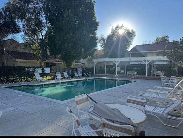 pool featuring a patio, fence, and a pergola