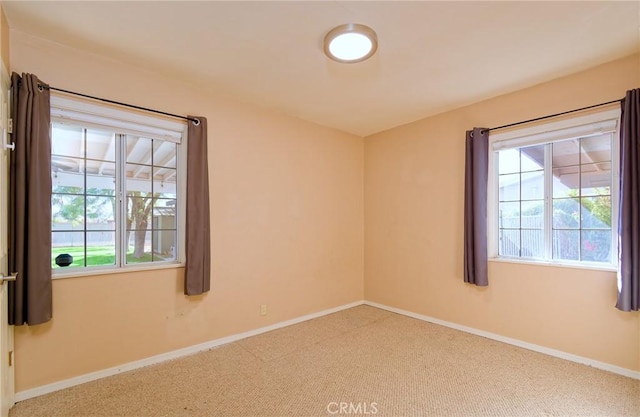 unfurnished room featuring carpet flooring and baseboards