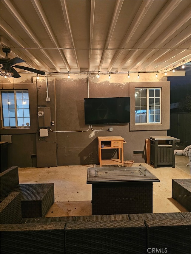 interior space featuring a ceiling fan and concrete floors