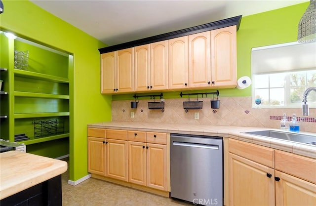 kitchen featuring a sink, light brown cabinets, tile counters, and stainless steel dishwasher