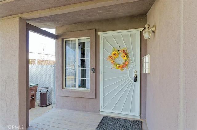 entrance to property with stucco siding