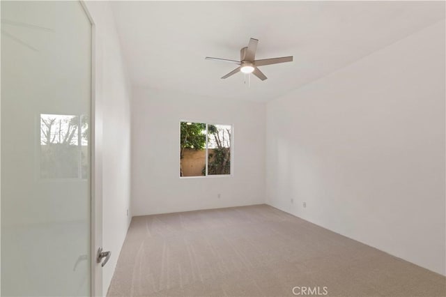 spare room featuring carpet and ceiling fan