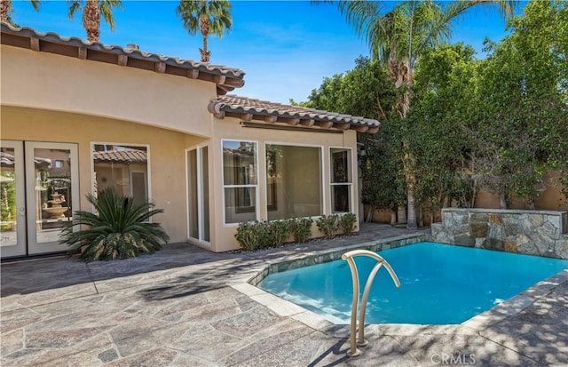 outdoor pool with a patio area