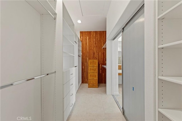 spacious closet with light tile patterned floors