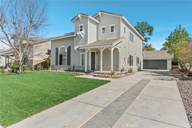 view of front of property with a garage, an outbuilding, a porch, and a front yard