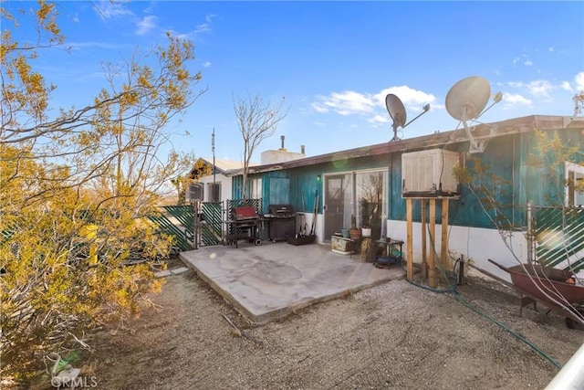 rear view of property with a patio area and fence