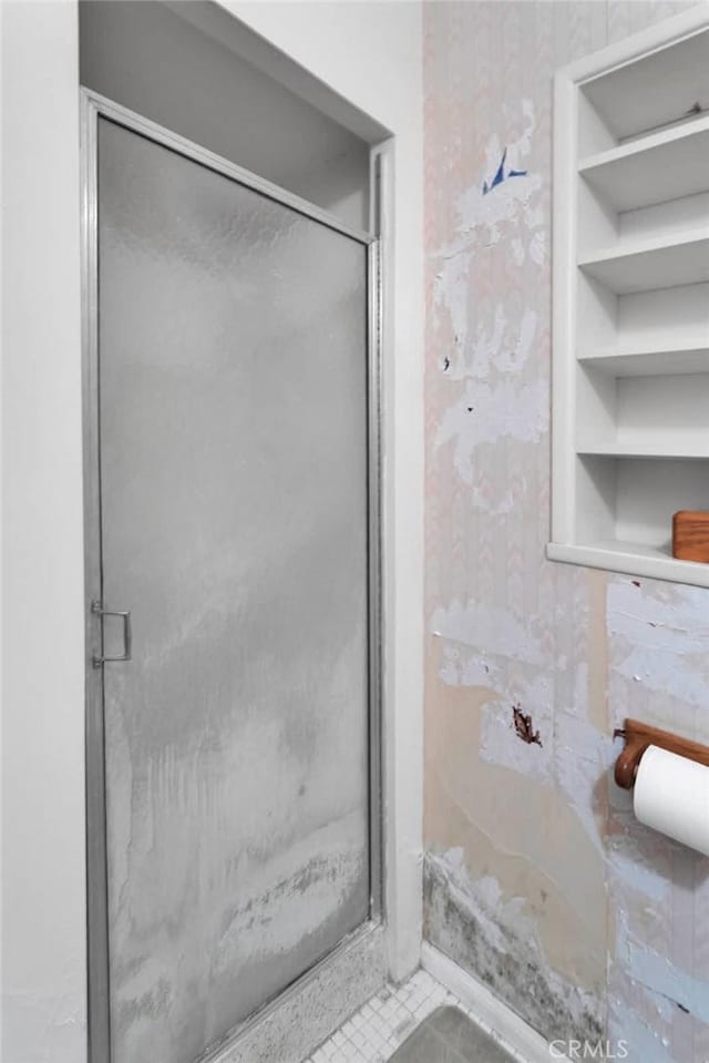 full bath with a shower stall and tile patterned floors