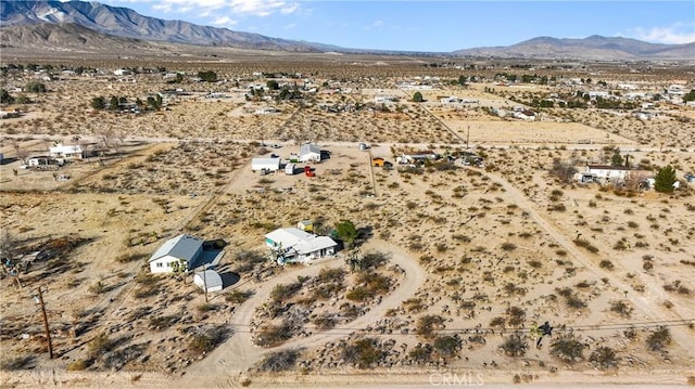 birds eye view of property with a desert view and a mountain view