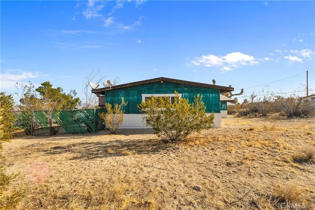 view of side of home with fence