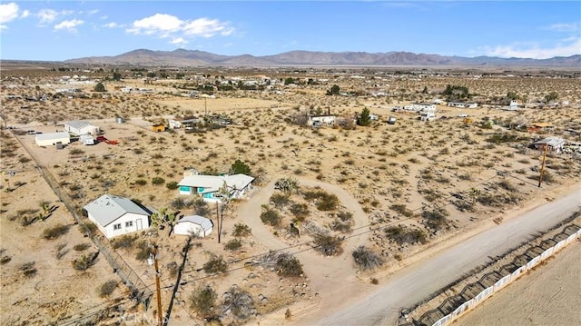 birds eye view of property featuring a mountain view and view of desert