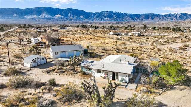 birds eye view of property featuring a mountain view and view of desert