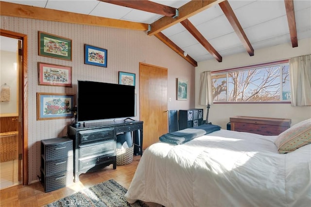 bedroom featuring lofted ceiling with beams and wallpapered walls