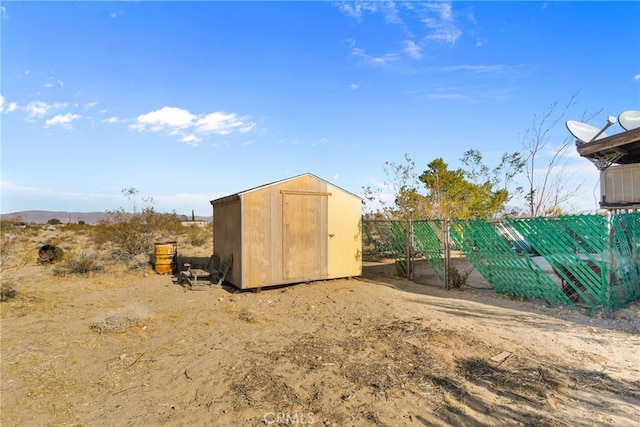 view of shed with fence