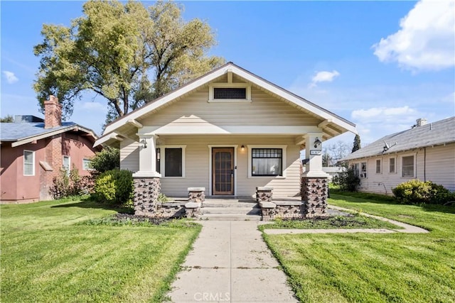 view of front of house featuring covered porch and a front lawn