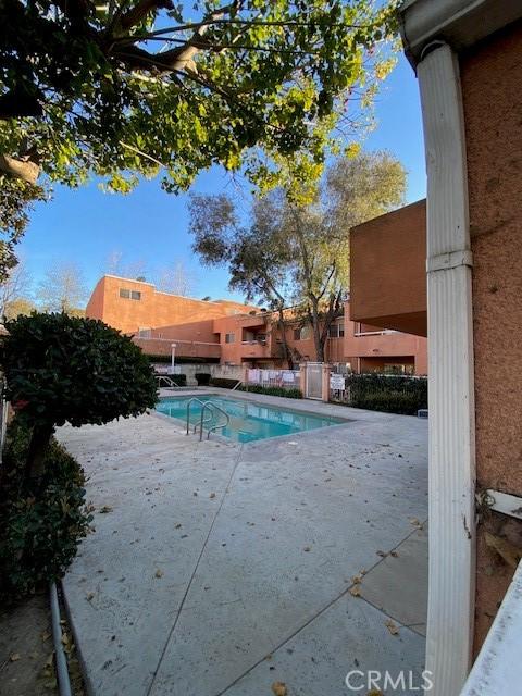 view of swimming pool with fence, a fenced in pool, and a patio