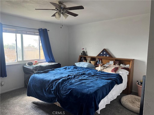 carpeted bedroom featuring ceiling fan and baseboards