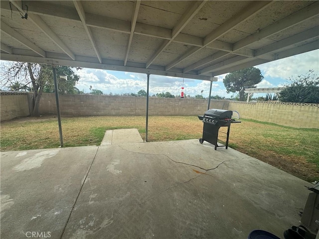 view of patio with area for grilling and a fenced backyard