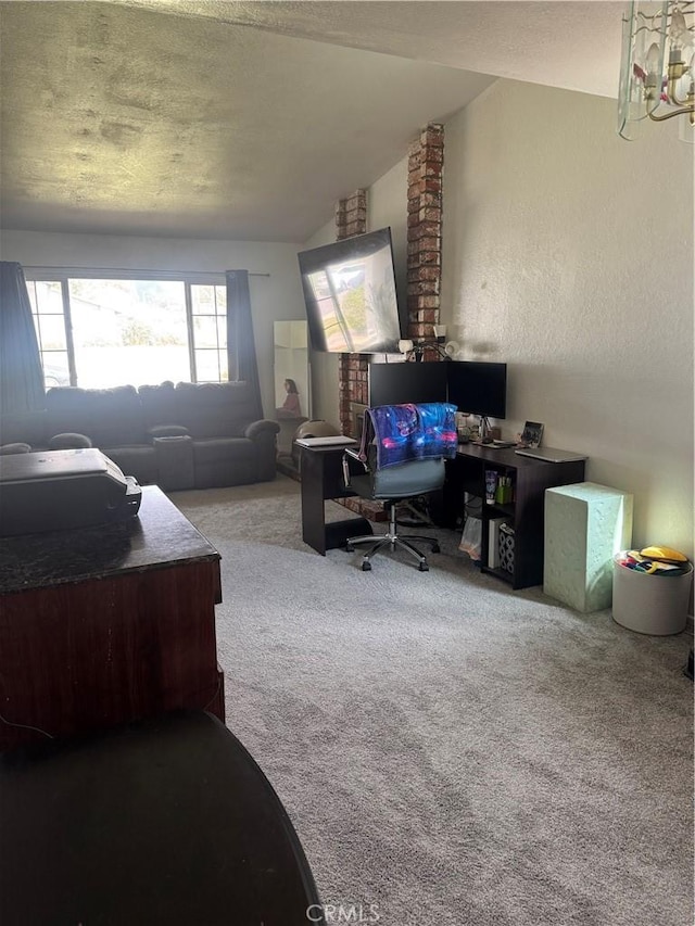 bedroom featuring carpet floors, lofted ceiling, and a textured wall