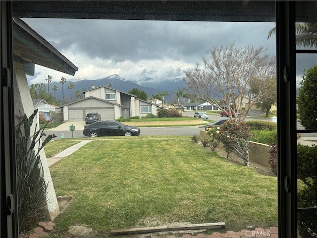 view of yard with a residential view and a mountain view