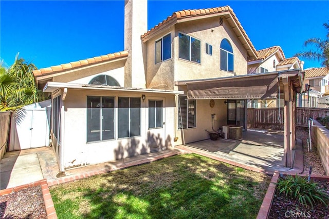 rear view of property with central AC unit, a patio area, a fenced backyard, and stucco siding