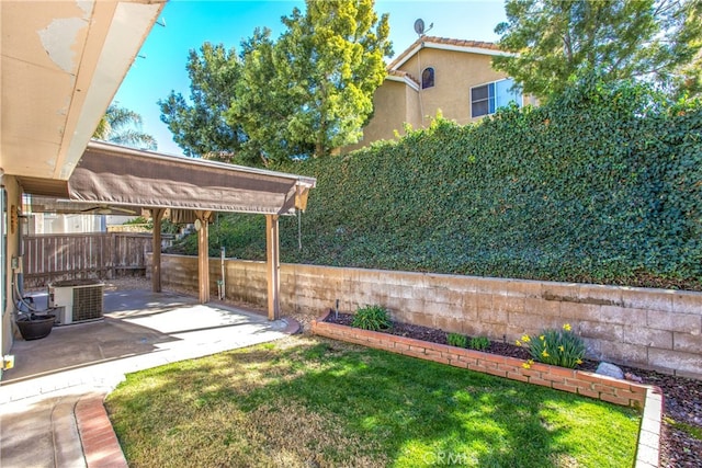 view of yard featuring cooling unit, a fenced backyard, and a patio