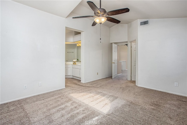 unfurnished bedroom with visible vents, baseboards, a ceiling fan, light colored carpet, and ensuite bath