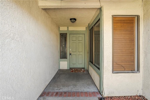 property entrance featuring stucco siding