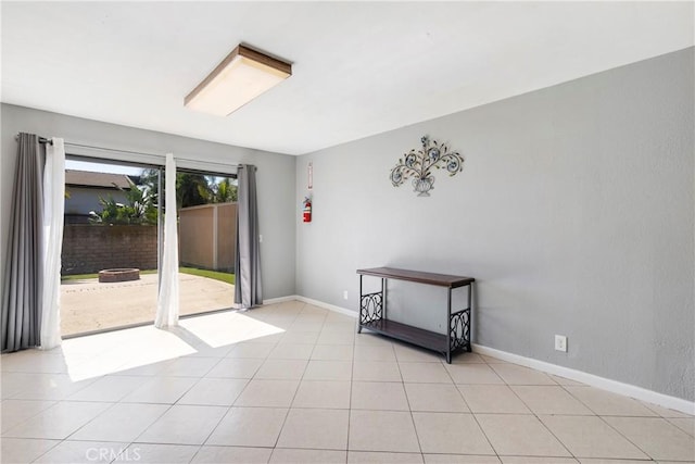 interior space featuring light tile patterned floors and baseboards