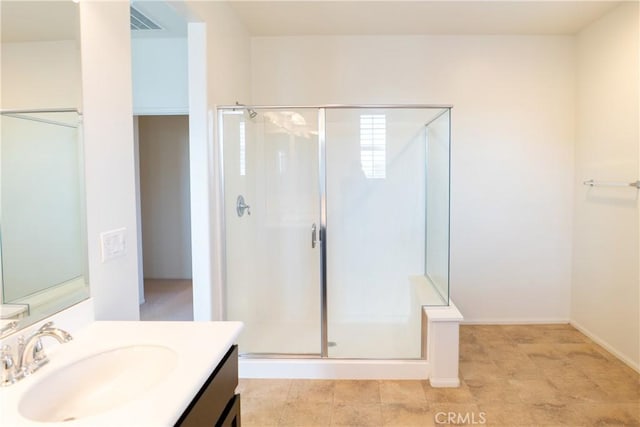 bathroom with a shower stall, visible vents, and vanity