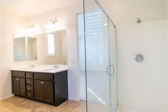 full bath featuring tile patterned flooring, a shower with door, a sink, and double vanity