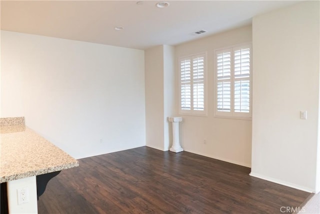 interior space featuring dark wood finished floors, visible vents, and recessed lighting