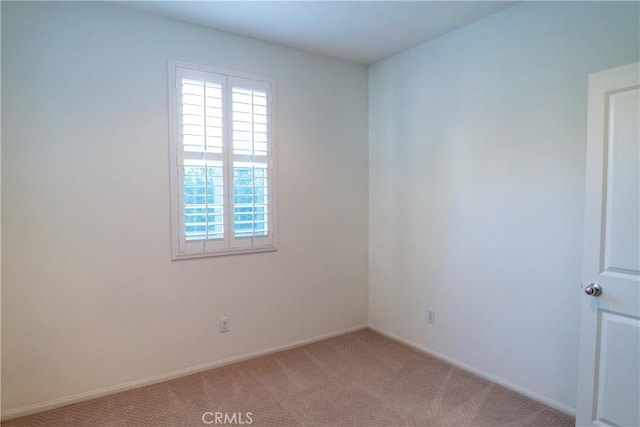 carpeted empty room with baseboards