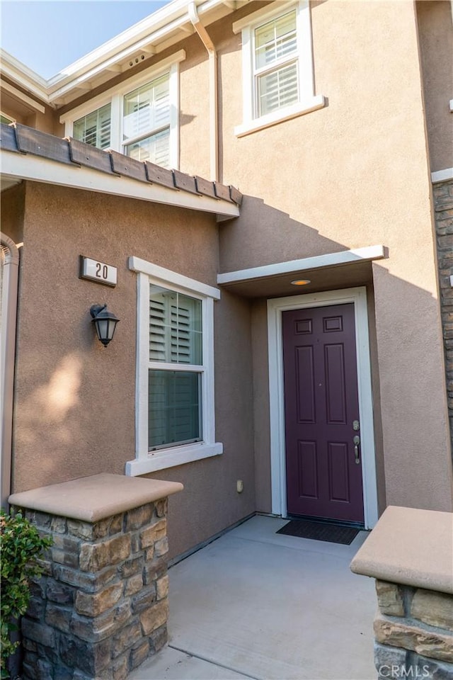 doorway to property with stucco siding