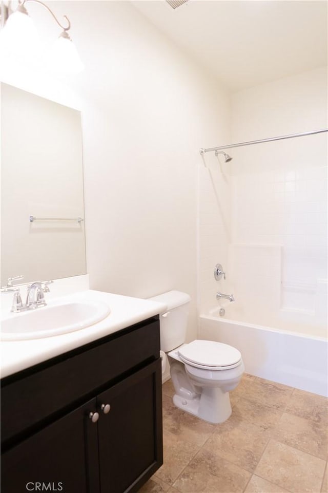 bathroom with vanity, toilet, and bathing tub / shower combination