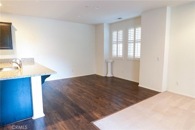 interior space with visible vents, dark wood-style flooring, and a sink