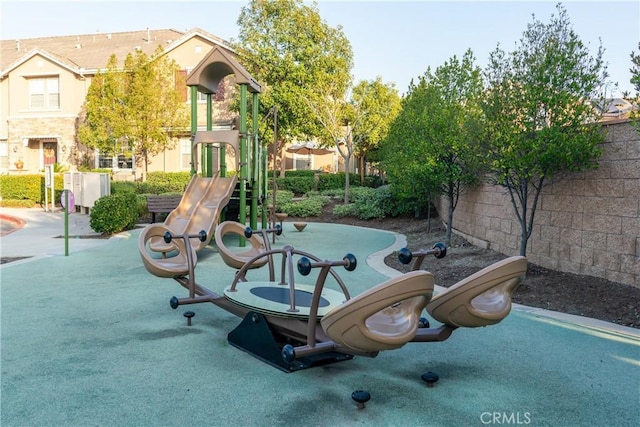 view of community featuring playground community and fence