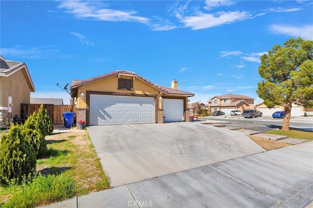 ranch-style home with an attached garage, brick siding, fence, driveway, and stucco siding