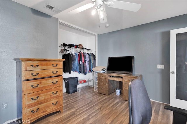 home office featuring visible vents, ceiling fan, and wood finished floors