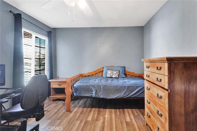 bedroom with ceiling fan and light wood-style flooring