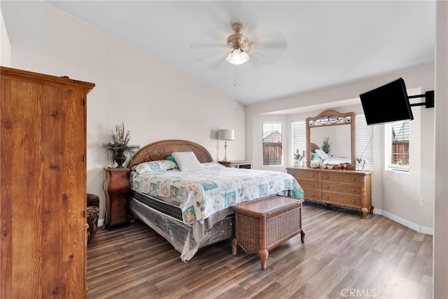 bedroom featuring lofted ceiling, ceiling fan, wood finished floors, and baseboards