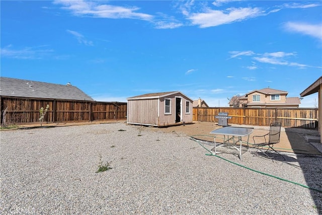 view of yard featuring an outbuilding, a fenced backyard, a patio, and a shed