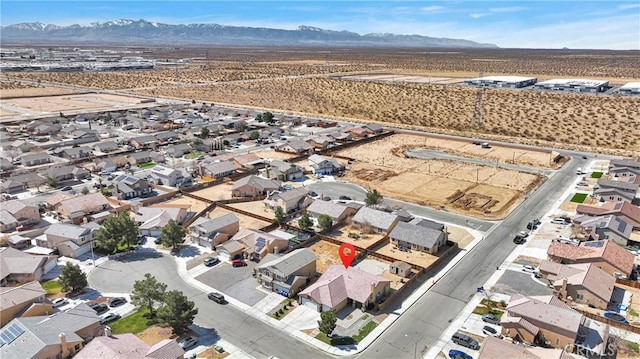 bird's eye view featuring a residential view, a desert view, and a mountain view