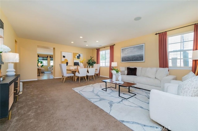 living room featuring baseboards, dark colored carpet, and recessed lighting