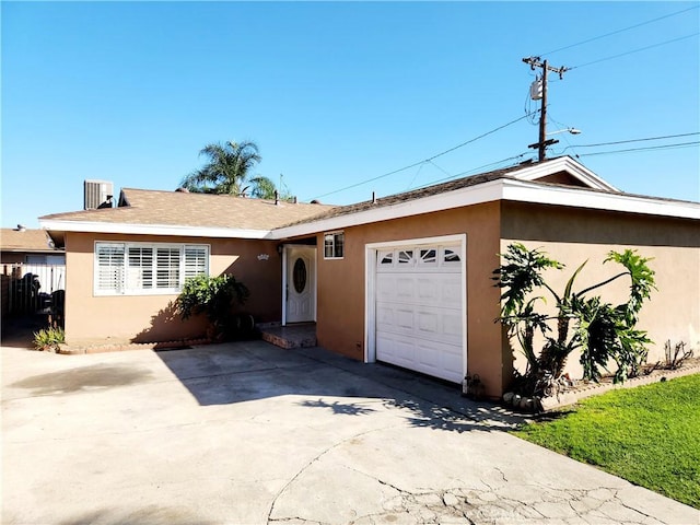 single story home featuring a garage, driveway, and stucco siding