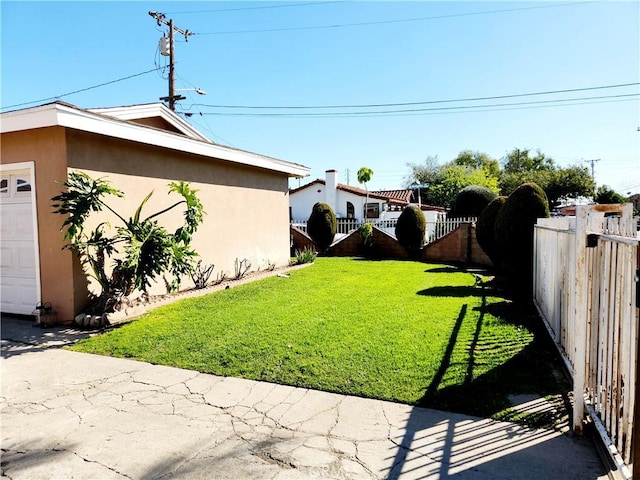 view of yard with a garage and fence