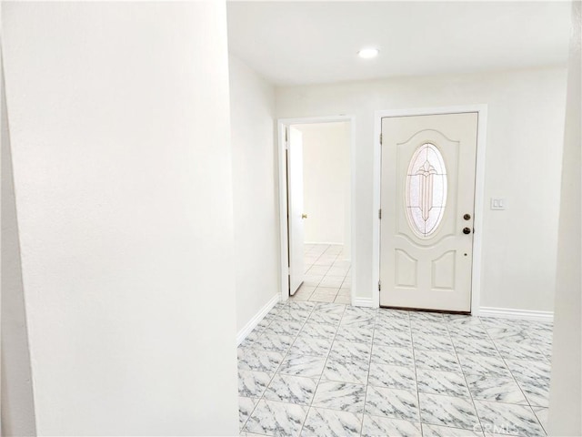 entryway with marble finish floor and baseboards