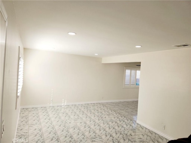 empty room featuring recessed lighting, marble finish floor, visible vents, and baseboards