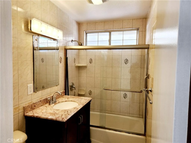 bathroom featuring vanity, toilet, and bath / shower combo with glass door