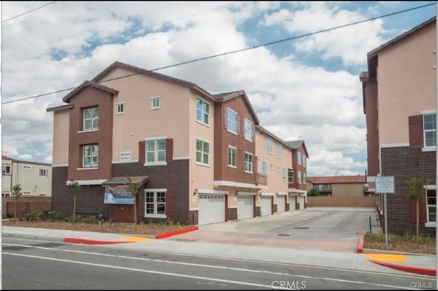 view of building exterior with an attached garage and driveway